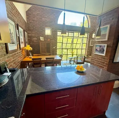 a kitchen with a counter with a bowl of fruit on it at Urban Oasis loft in Stellenbosch in Stellenbosch