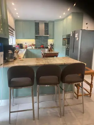 a kitchen with a counter with two chairs and a counter top at 8 Sleeper, 4 Bedroom Home in Franschhoek in Franschhoek