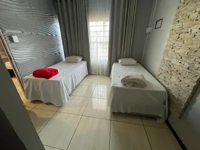 a room with two beds and a red pillow at Ayan Contractors & Student Accommodation in Avondale