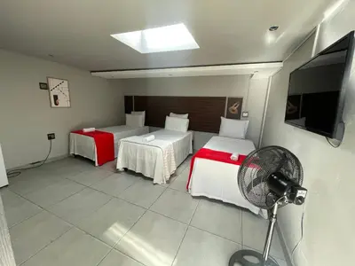 a room with two beds and a fan and a television at Ayan Contractors & Student Accommodation in Avondale