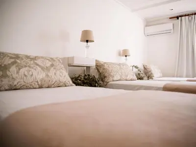 a hotel room with two beds and a couch at Morgenzon Farm in Wellington