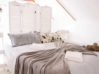a white bed with two towels on top of it at Morgenzon Farm in Wellington