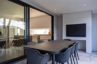 a dining room with a table and chairs at Luxury Golf Villa 710, Pearl Valley Golf Estate in Simondium
