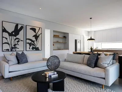 a living room with two couches and a table at Luxury Golf Villa 710, Pearl Valley Golf Estate in Simondium