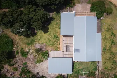 an aerial view of a white building in a field at Swallows Perch Beach Getaway - Solar Backup in Bettyʼs Bay