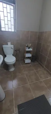 a bathroom with a toilet and a sink at The Resting Nest in Mandalay