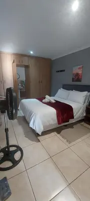 a bedroom with a large bed and a camera on a tripod at The Resting Nest in Mandalay
