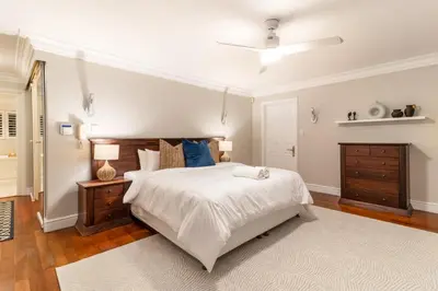 a bedroom with a large white bed and a dresser at 