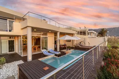 a house with a swimming pool and a balcony at 