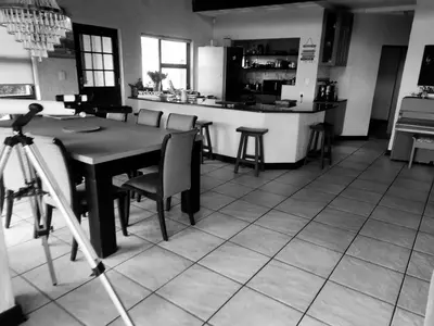 a kitchen with a table and chairs and a counter at La Mer in Bettyʼs Bay