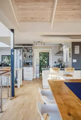 a kitchen with white appliances and a wooden ceiling at Onrus Beach House in Hermanus