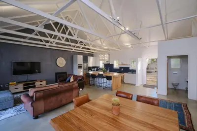 a living room with a table and a dining room at Esperon in Stellenbosch