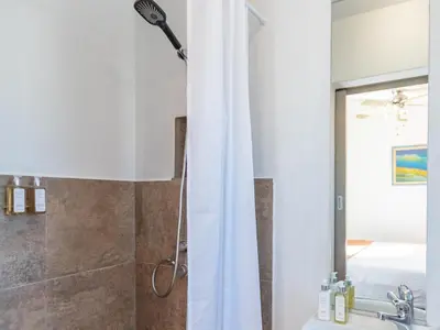 a bathroom with a shower curtain and a sink at Cape Town 4U Guesthouse in Cape Town