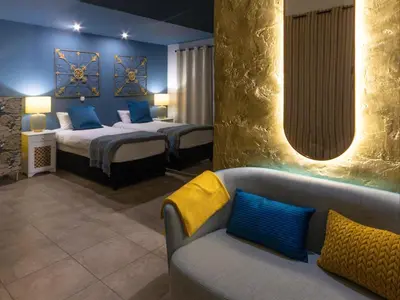 a hotel room with two beds and a couch at Cape Town 4U Guesthouse in Cape Town