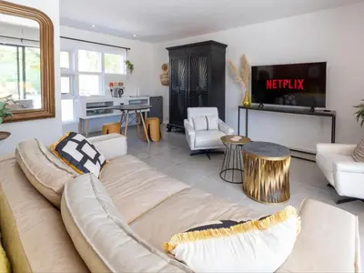 a living room with a couch and a tv at Cape Town 4U Guesthouse in Cape Town