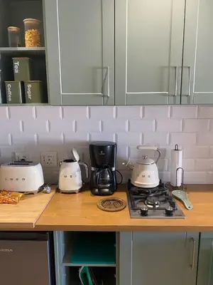 a kitchen counter with three toasters on top of a stove at Pistachio - Paarl - Self Catering Apartment in Paarl