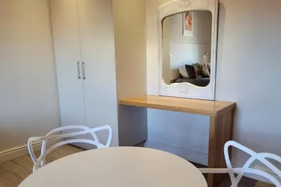 a dining room with a table and a mirror at Whale Watchers studio in Hermanus