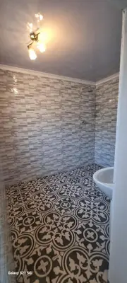 a bathroom with a ceiling fan and a tub at Neo & Ruks Guest Houses Boston Belleville 6 in Bellville