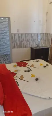 a bed with a comforter with autumn leaves on it at Neo & Ruks Guest Houses Boston Belleville 6 in Bellville