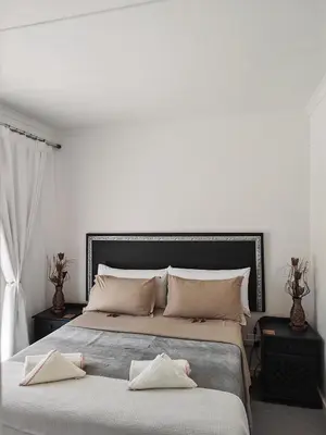 a bedroom with two beds with towels on them at Somerset west Stay 1 in Somerset West