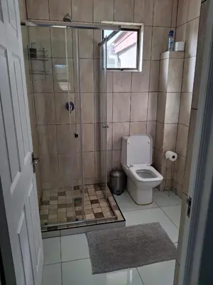 a bathroom with a shower and a toilet at Comfey Stay in Somerset West