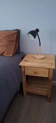 a lamp on a night stand next to a bed at 33 on Vermont in Hermanus