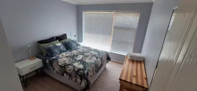 a bedroom with a bed and a window at 33 on Vermont in Hermanus
