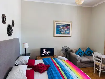 a bedroom with a bed with a colorful blanket at Peaceful getaway in Cape Town