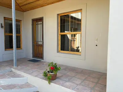 an empty house with a window and a potted plant at Cozy en-suite room in Wellington with own entrance in Wellington