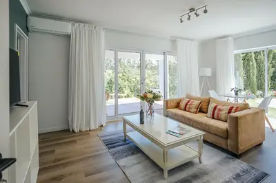 a living room with a couch and a table at On Helderberg in Somerset West