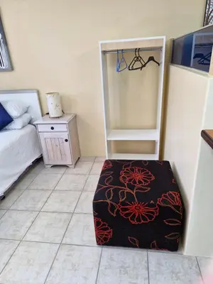 a bedroom with a bed and a rug on the floor at 22 on Shiraz in Hoheizen