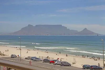 a view of a beach with people and cars parked at Witsand 303 in Cape Town