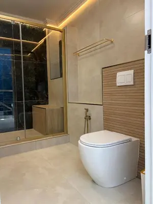 a bathroom with a white toilet and a shower at Ultra Luxury 3 Bed Knightsbridge Penthouse in Cape Town