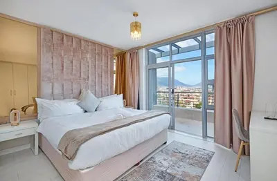 a bedroom with a large bed and a large window at Ultra Luxury 3 Bed Knightsbridge Penthouse in Cape Town