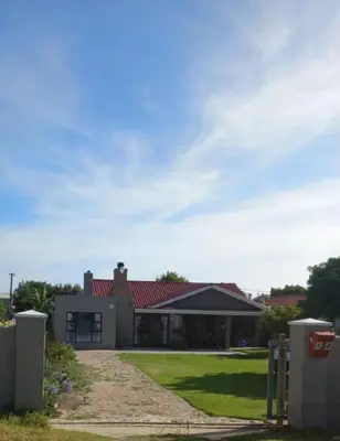 a house with a red roof at Rosa Villa in Hermanus