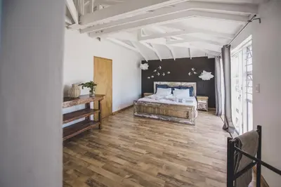 a bedroom with a bed and a wall with stars at Surfers Lodge in Cape Town