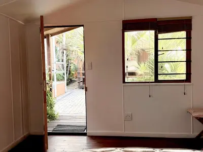 an open door to a room with a window at Surfers Lodge in Cape Town