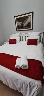 a bedroom with two white towels on a bed at Firehouse selfcatering Garden Cottage no 1 in Wellington