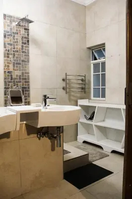 a bathroom with a sink and a mirror at Firehouse selfcatering Garden Cottage no 1 in Wellington