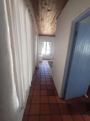 a hallway with a tiled floor and a door at Holiday Vibe in Hermanus