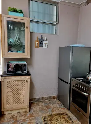 a kitchen with a stainless steel refrigerator and a microwave at UITZICHT STAY Durbanville Pet Friendly in Oakdale