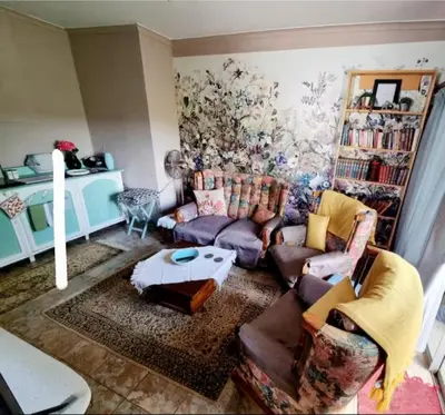 a living room with a couch and a table at UITZICHT STAY Durbanville Pet Friendly in Oakdale