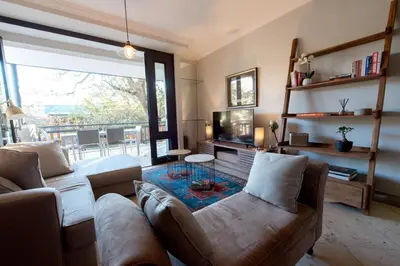 a living room with a couch and a table at Oude Hoek, Stellenbosch Central in Stellenbosch
