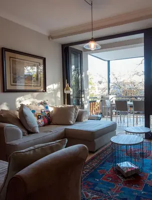 a living room with a couch and a table at Oude Hoek, Stellenbosch Central in Stellenbosch