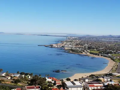 an aerial view of a city and a beach at 'Country Beach House' - Traditional Family Vacation Home for 6 - Near Beach in Gordonʼs Bay