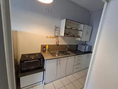 a small kitchen with a sink and a microwave at Comfort and calm zone in Cape Town