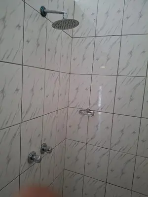 a shower with a glass door with a shower head at Comfort and calm zone in Cape Town