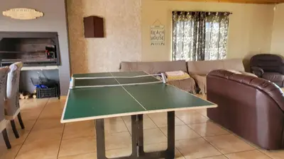 a ping pong table in a living room at Judea Accommodation in Bettyʼs Bay