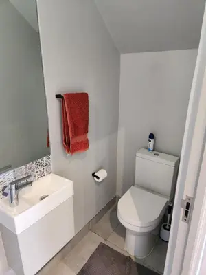 a bathroom with a white toilet and a sink at St James home in Somerset West