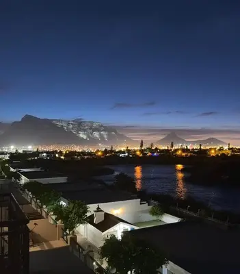 a view of a city at night at Loft apartment by the lake in Cape Town
